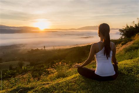 Peaceful Woman Meditating On A Mountain At Sunrise by Soren Egeberg