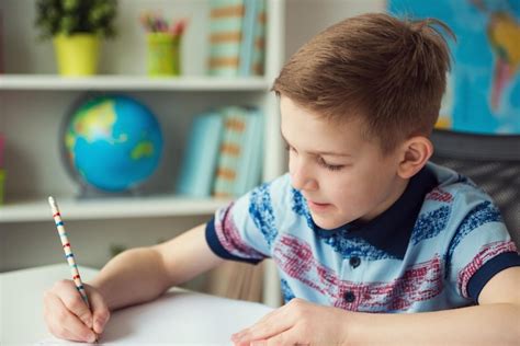 Premium Photo | Close-up of boy writing homework