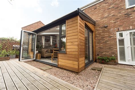 Cedar Wood Clad Conservatory with Bi-Fold Doors