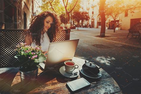 Girl is working with laptop in cafe | People Images ~ Creative Market