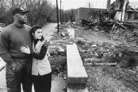 Pro football player Reggie White & wife Sara walking past burnt... News Photo - Getty Images