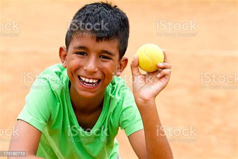 Boy Picking Up A Tennis Ball Stock Photo - Download Image Now - Tennis, Adult, Athleticism - iStock