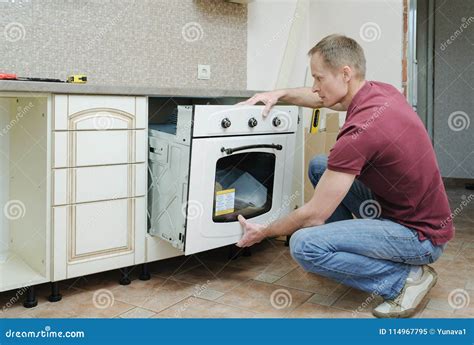 Installation of the Built-in Electric Oven. Stock Image - Image of installation, classic: 114967795