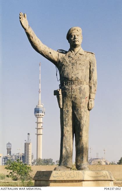 A statue of Saddam Hussein in central Baghdad is battered but still standing, following the ...