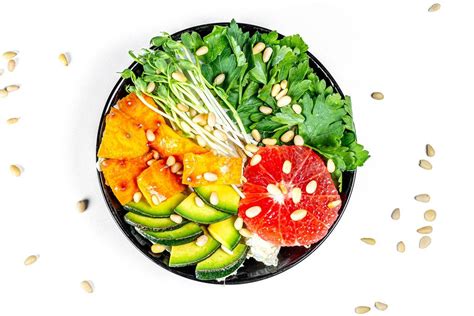 Salad with grapefruit, avocado, micro greenery and pine nuts on a white background. Top view ...