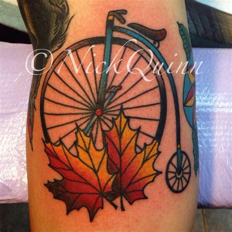 Penny-farthing, bicycle, big-wheel bike with maple leaves.