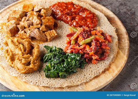 Ethiopian Injera Topped with Meat, Vegetables, Greens Close Up on the ...