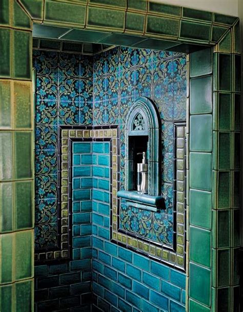 a bathroom with blue and green tiles on the walls