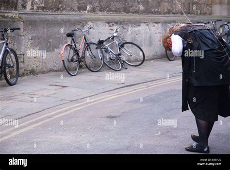 Oxford University student in subfusc covered in food and holding the ...