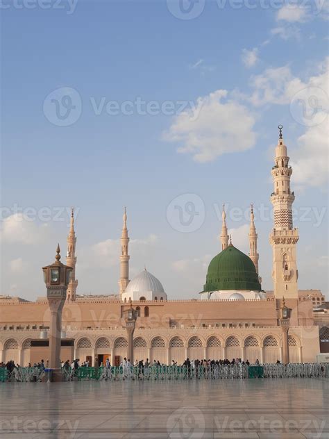 Beautiful daytime view of Masjid Al Nabawi, Medina's green dome, minarets and mosque courtyard ...