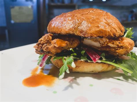 Homemade fried chicken sandwich - homemade buns with lemon-pepper mayo, hot sauce, pickled ...