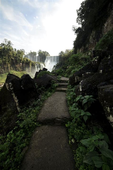 Narrow path in green valley near amazing waterfall · Free Stock Photo