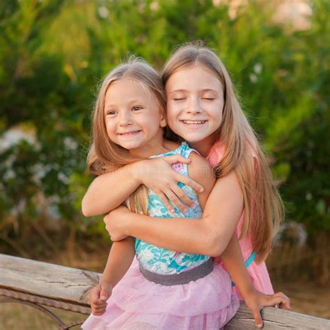 Two Little Girls Sisters Hugging and Having Fun in Park. Stock Image - Image of leisure, family ...