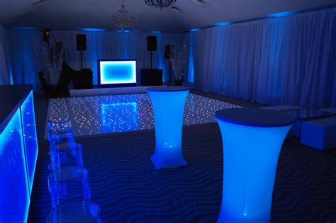 Blue wall uplighters, illuminated DJ booth, illuminated bar, white ...