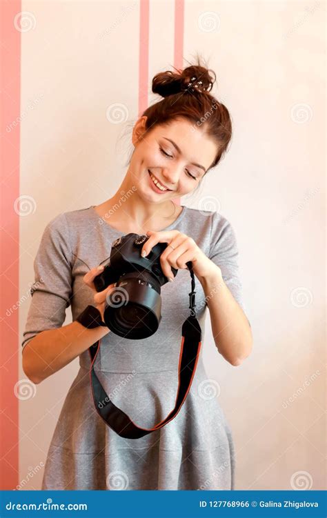 Portrait of Young Woman Photographer Smiling and Holding Her Camera Stock Photo - Image of lens ...