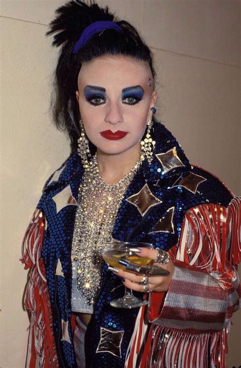 a woman in costume holding a martini glass