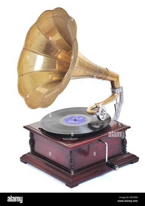 retro old gramophone for playing music over plates isolated on white in ...