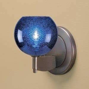 a blue glass ball mounted on the side of a metal wall light with a white background