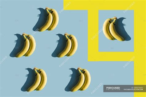 Rendering bananas with fake eyelashes on blue background with yellow lines — art, ripe - Stock ...