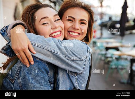 Close-up photo of two attractive happy woman friends hugging each Stock ...