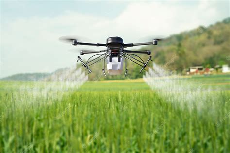 Premium Photo | Drone spraying pesticide on wheat field