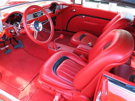 the interior of an old car with red leather seats