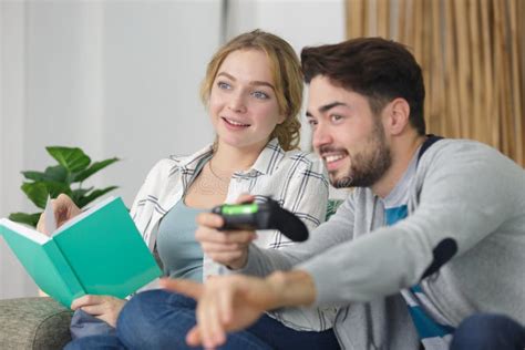 Boyfriend Playing Video Games and Girlfriend Reading Book Stock Image - Image of game, home ...