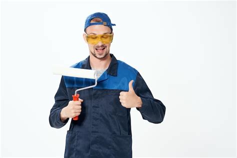 Premium Photo | Man in work uniform wall painting repair service