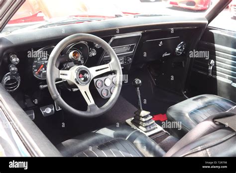 Classic American Muscle car interior including steering wheel, dash, gear shifter. Taken at a ...