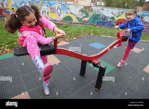 See saw playground ethnic child hi-res stock photography and images - Alamy