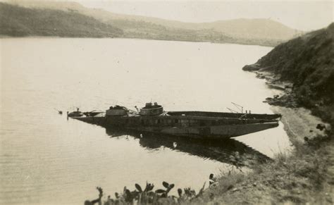 Damaged German landing ferry/barge lying in shallow water, Porto Azzurro, Elba Island, Italy ...