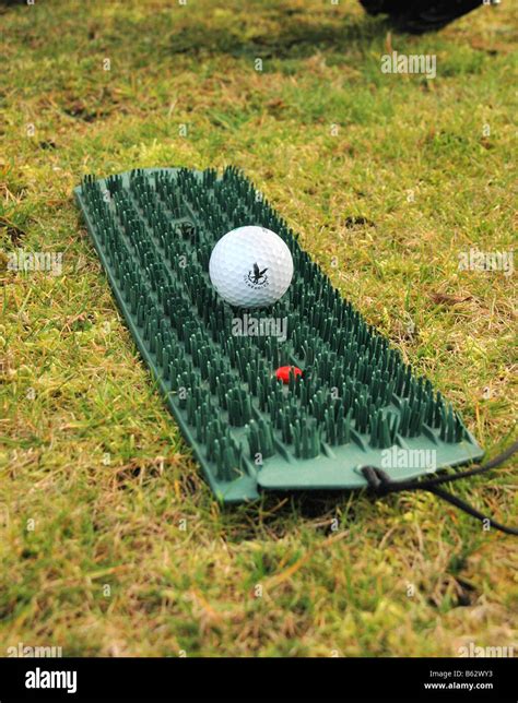 A golf mat for winter use and golf ball Stock Photo - Alamy