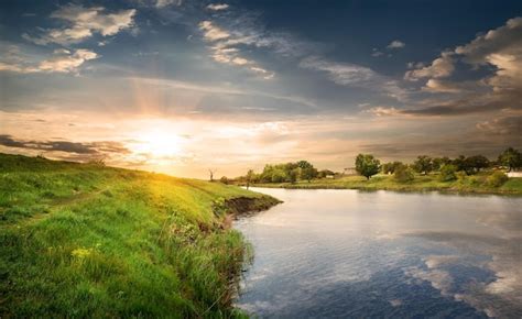 Premium Photo | Reflection in the calm river at sunset