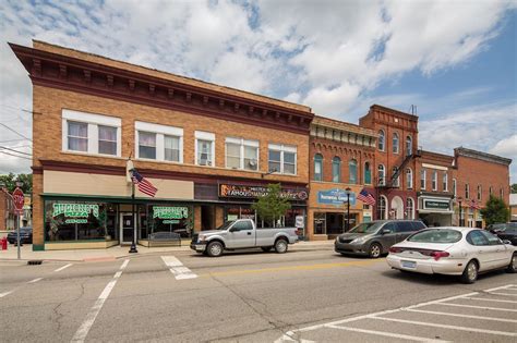 several cars are parked on the street in front of buildings