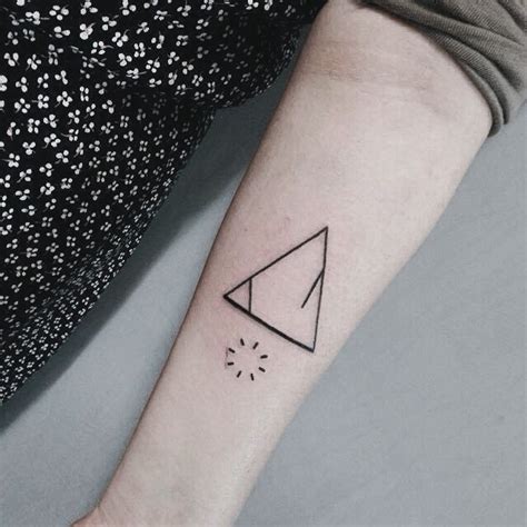 Tiny black ink mystical triangle tattoo on forearm with interesting ...