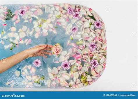 Top View of Bath Filled with Blue Bubble Water, Flowers and Petals with Woman`s Hand Stock Image ...