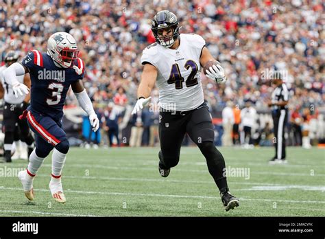 Baltimore Ravens fullback Patrick Ricard runs against the New England Patriots during an NFL ...