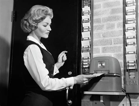 1960s Woman Punching Time Clock At Work Photograph by Vintage Images