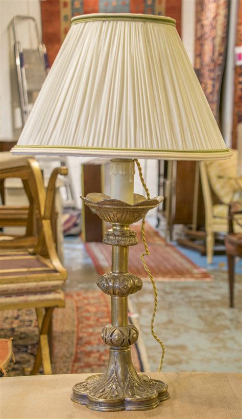 LAMP BASES, a pair, gilt metal with cast decoration, 62cm H overall (with shades). (2)