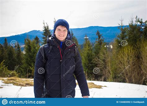 Happy Young Boy On Top Of Mountain With Snow Covered Trees Admiring Beautiful Valley View In ...