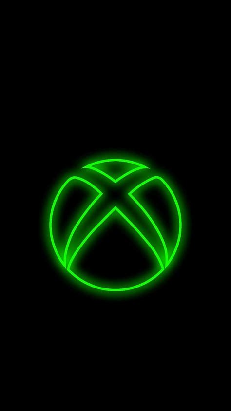 the xbox logo is glowing green in the dark