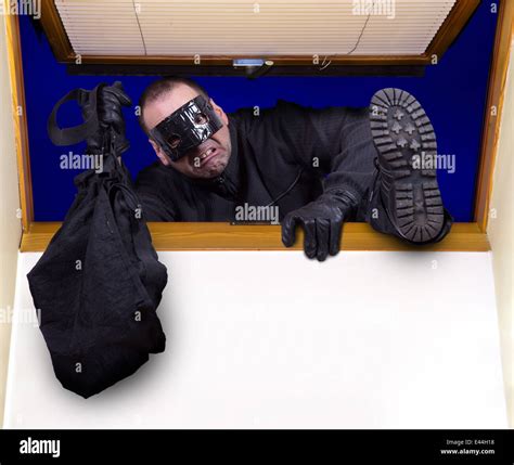 A robber enters the house through the roof window Stock Photo - Alamy