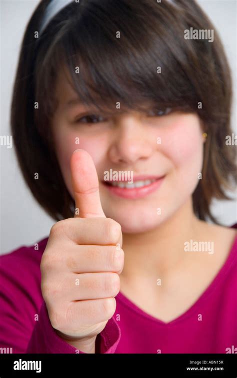 Young 11 year old girl giving the thumbs up sign Stock Photo - Alamy
