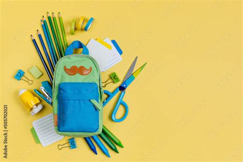 School stationery on yellow background. Pencil case with stationery supplies. Concept back to ...