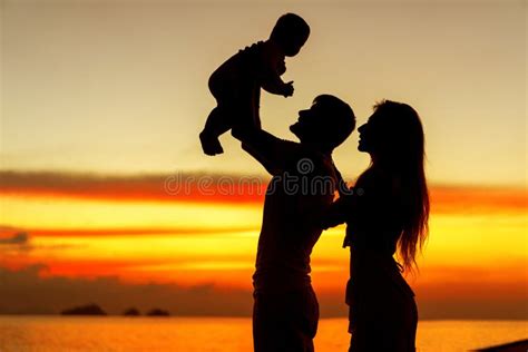 .Family in Love with Son Hugging at Sunset, Silhouette Stock Image ...