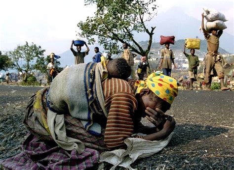 File photo of a Rwandan woman collapsing with her baby on her back ...