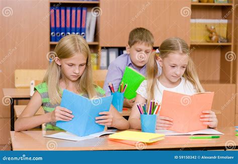 Primary School Children In The Classroom Reading Books Stock Photo ...