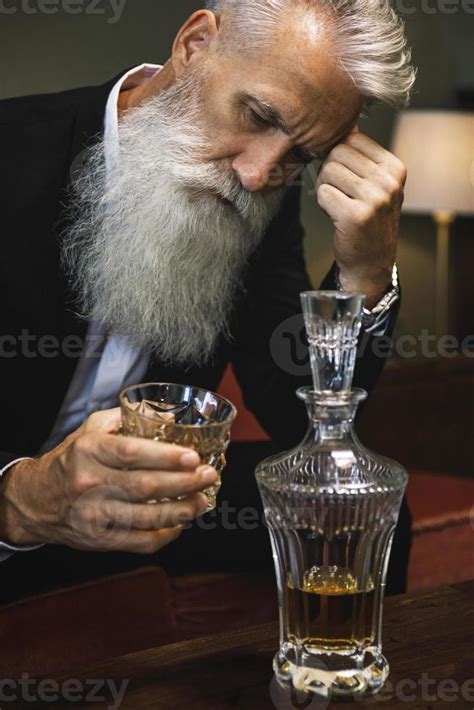 Handsome and bearded senior man drinking whiskey 16250468 Stock Photo ...