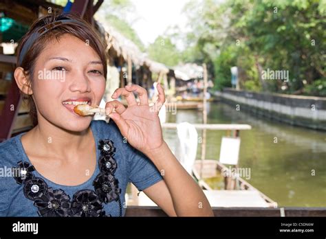 Young woman tasted fried chicken Stock Photo - Alamy