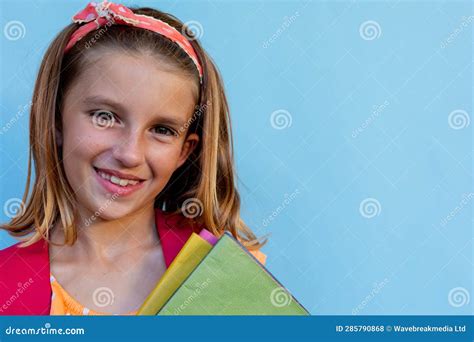 Happy Caucasian Schoolgirl with School Bag and Books Over Blue Background at Elementary School ...